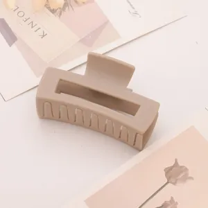 Matte khaki geometric hair claw clip, simple design for daily styling, detail closeup view.