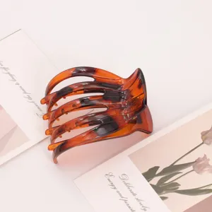 Detailed view of the elegant tortoiseshell plastic hair claw clip minimalist style.