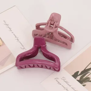 Minimalist plastic hair claw clips set in pink and purple, chic daily styling accessories.