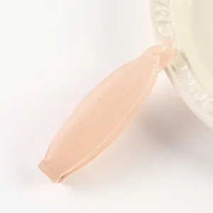 Detailed view of translucent jelly pink hair claw clip with cute dot texture for daily styling.
