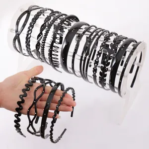 Detailed view showing multiple black rhinestone and wavy hair hoops displayed on a clear stand.