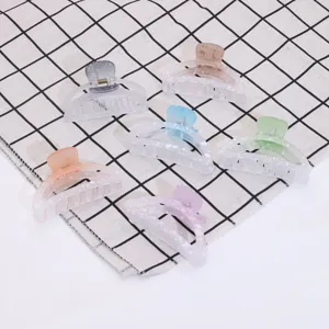 Set of colorful plastic hair claw clips with speckled translucent design for women daily wear.