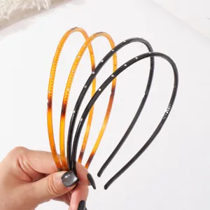 Close-up detail of thin plastic rhinestone headbands with anti-slip teeth for daily hair styling.