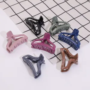 Detailed view of multiple colorful plastic hair claw clips showing various chic colors and shapes.