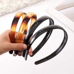 Close-up detail of rhinestone anti-slip plastic hairbands showing teeth and elegant gradient colors.