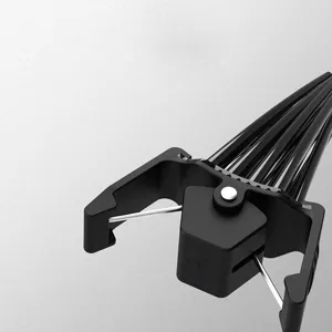 Close-up view of a black plastic hair root volume clip with metal structural details.