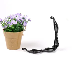 Black plastic banana hair clip for women, vintage mesh hair styling tool and daily accessory.