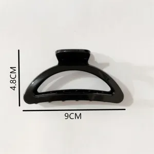 Detailed view of the black minimalist semicircle plastic hair claw clip with size dimensions.