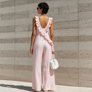 Detail shot of the back view of a pink sleeveless V-neck linen blend jumpsuit with ruffles.