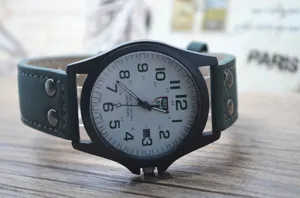 Men military quartz watch with matte black case, green leather strap and calendar display.
