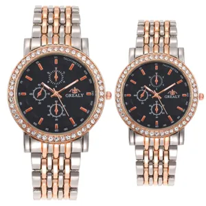 Detailed shot of couple quartz watch, rhinestone bezel, metal strap, three sub-dials style.