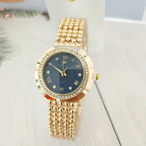 Elegant women's gold quartz watch with rhinestone bezel, blue dial and Roman numerals.
