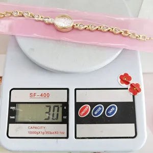 Detail shot of elegant rhinestone teardrop women bracelet watch on scale for quality check.