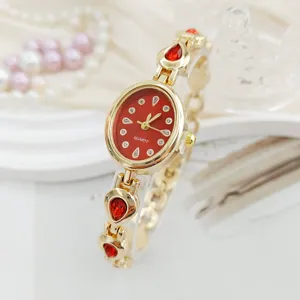 Exquisite oval quartz watch with red dial, gold-tone teardrop rhinestone bracelet for women.