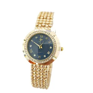 Luxury gold women quartz watch with blue dial, rhinestone bezel and unique beaded metal strap.