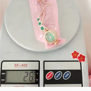 Fashion women quartz watch with green dial rhinestones and adjustable pull bracelet luxury style.