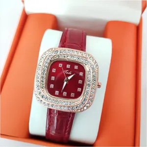 Close-up detail of women quartz watch featuring square rhinestone bezel and red leather strap.