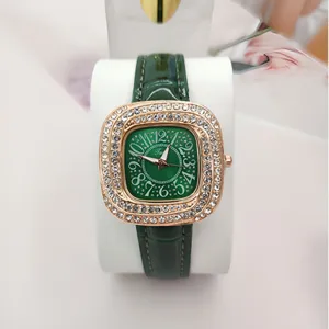 Green square rhinestone quartz watch for women with leather strap and elegant dial design.
