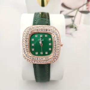 Green dial square rhinestone quartz watch for women with luxury leather strap and diamond bezel.