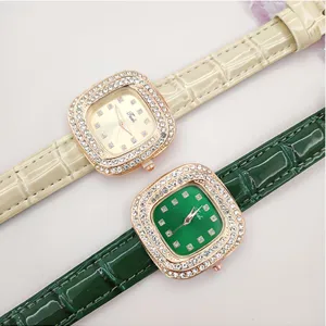 Detailed close-up of square rhinestone quartz watches with elegant leather straps in beige and green.