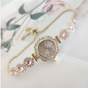 Elegant rhinestone flower dial quartz watch with pink charm sliding chain bracelet.