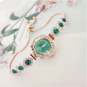 Elegant rose gold quartz ladies watch with green dial and sparkling rhinestone bracelet strap.
