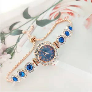 Exquisite women quartz watch with blue dial, rhinestone flower bezel, and pull-chain bracelet.