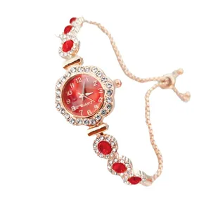 Women rose gold quartz watch with crystal rhinestone flower bezel and red bracelet strap.