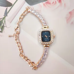 Elegant rose gold square quartz watch with glittering rhinestones and chain bracelet strap.