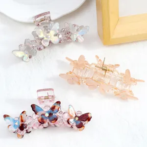 Vista dettagliata di mollette per capelli a farfalla da 8cm con strass, stile pinza in PVC.