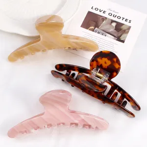Acetate hair claw clips in stylish solid and tortoiseshell colors, perfect for daily styling.