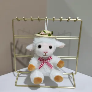 Cute plush lamb keychain pendant with straw hat and bow, soft toy hanging detail view display.