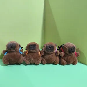 Detail view of cute capybara plush toys with colorful mini backpacks, soft pendant dolls for bags.