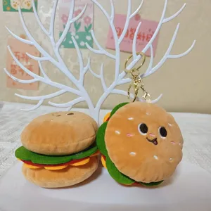 Cute hamburger plush keychain closeup detail showing soft fabric texture and cute face.