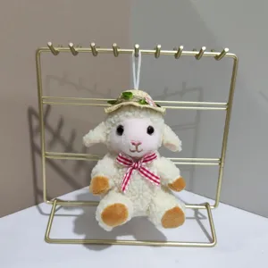 Cute plush sheep pendant with straw hat and bow, perfect bag charm and keychain accessory.