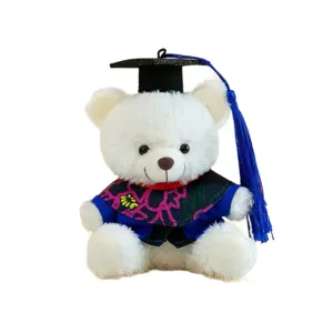 Ours en peluche de graduation avec chapeau noir et robe bleue, parfait cadeau pour étudiant.