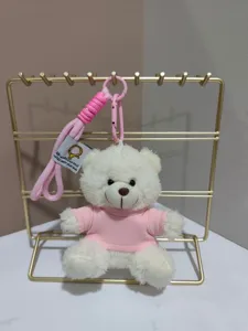 Cute white plush bear keychain pendant with pink sweater and strap for backpack and bag decoration.