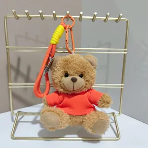 Cute plush teddy bear keychain, orange doll bag charm and backpack pendant accessory.
