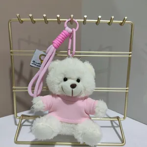 Cute white plush bear keychain with pink shirt, hanging plush doll pendant for backpack decor.