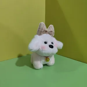 Simpatico ciondolo cucciolo in peluche con fiocco e campanello, giocattolo morbido per borsa.