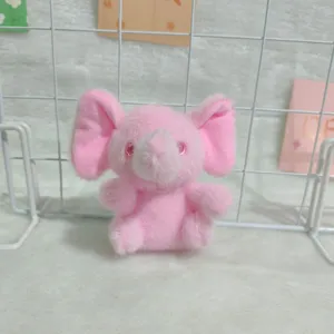 Cute pink elephant plush toy pendant close-up, soft furry cute doll bag accessory keychain.