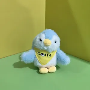 Vista dettagliata del simpatico pinguino di peluche, bambola morbida con mini sciarpa gialla.