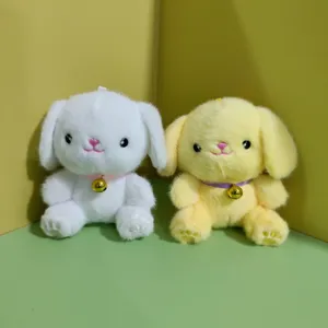 Cute plush puppy keychain detail shot, soft material with golden bell ornament for bag charm.