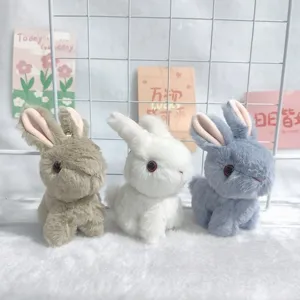 Detailed view of cute plush bunny keychains in brown white and blue soft fluffy toy pendants.