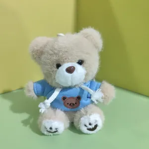 Cute plush teddy bear pendant detail showing soft toy in cute blue hoodie bag charm style.