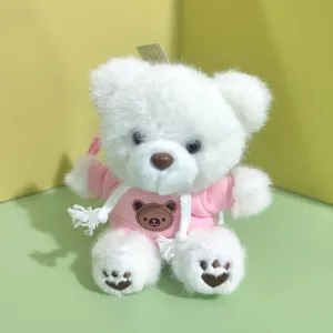 Cute plush teddy bear pendant toy wearing pink hoodie, soft stuffed doll bag accessory.