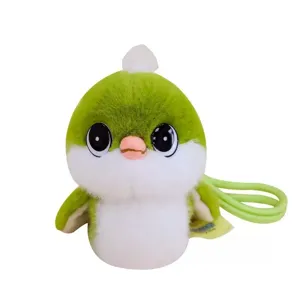Close-up detail of the cute little green plush bird pendant, showing soft fur and big eyes.