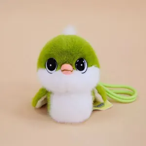 Close-up detail of cute green and white bird plush toy pendant with strap. Soft toy accessory.