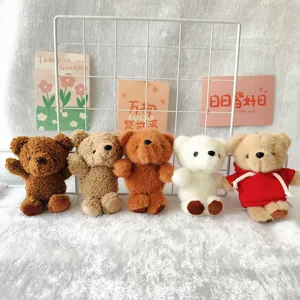 Close up detail shot of cute plush bear keychains displayed neatly on white grid background.