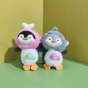 Cute vinyl plush penguin pendant doll pair with animal hoods and colorful belly fish accessory.